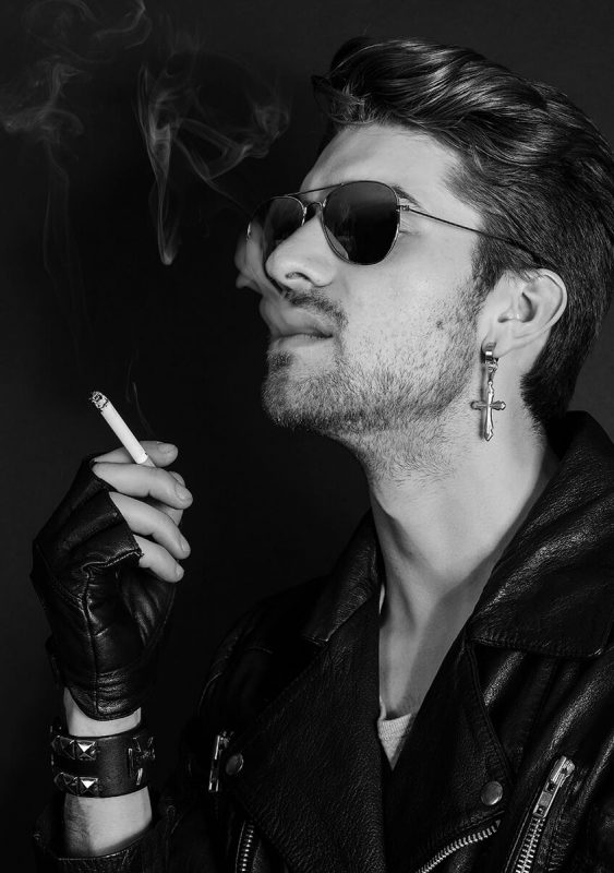 Man in leather jacket smoking.